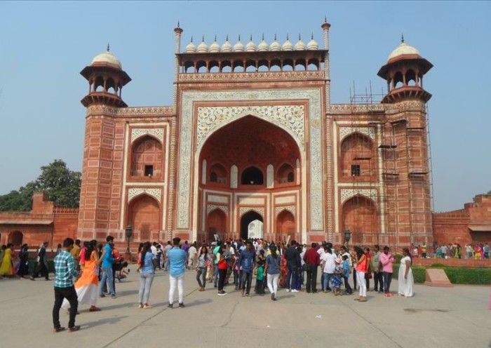 People entering Taj Mahal's huge main gate on a 1 day visit.