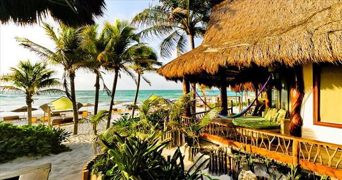 Ahau Tulum palm-thatched beach cabins on the Riviera Maya.