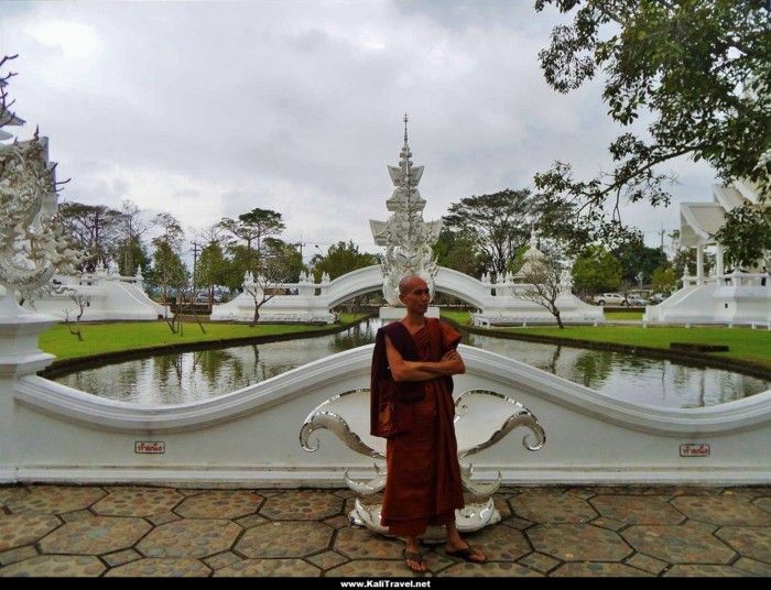 A Buddhist monk by the lake at the white temple.