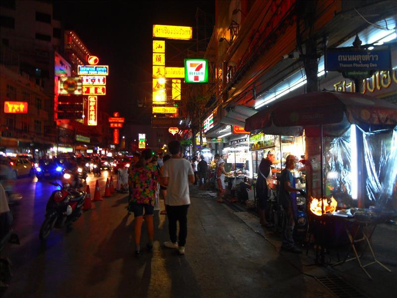Guys flaming street food in Bangkok's China Town.