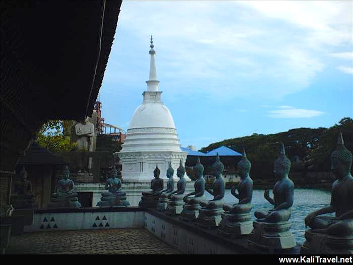 Sitting Buddhas and stupa at Seema Malaka Lake Temple.
