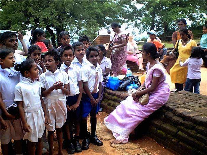 Sri Lanka teacher and school children on a trip at Sigiriya.