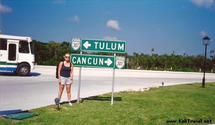 Me beside a Tulum Cancun signpost on the Riviera Maya highway!