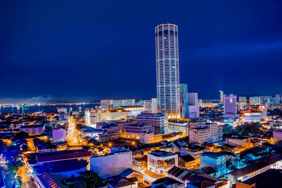 Georgetown cityscape lit up at night with Komptar tower in the middle.