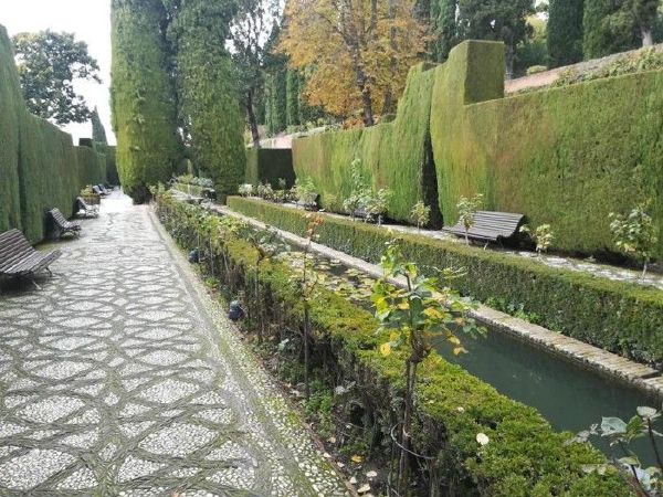 Stone path beside ornamental water channel in Alhambra Gardens, Granada.