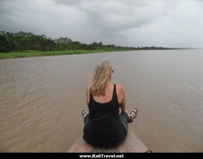 Riding into the storm on a canoe on the Amazon River, Loreto, Peru.