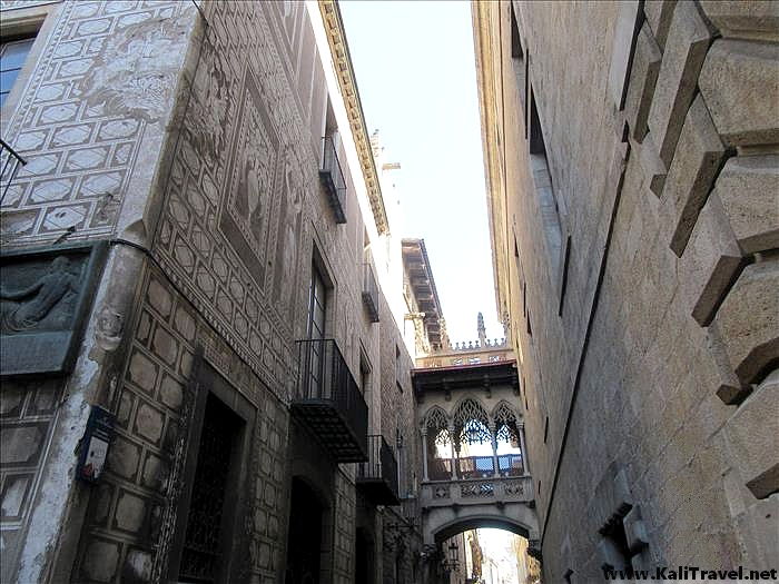 Ornate little stone bridge overhead passageway joining 2 medieval buildings.