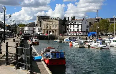 Waterfront with boats in the harbour, and historical buildings in the distance.