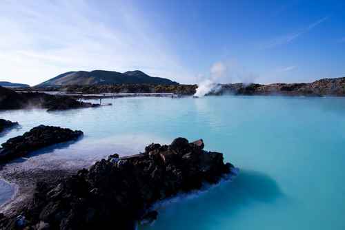 Volcanic rocks and milky water of Blue Lagoon geothermal spa in Iceland.