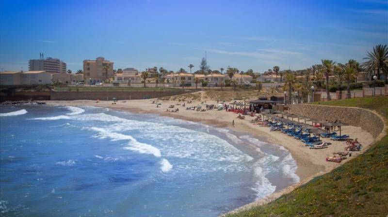 Shell-shaped Cala Estaca sandy cove in Playa Flamenca, Orihuela.