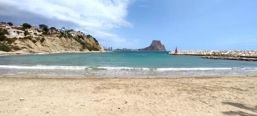 Sandy little bay with Calpe rock on the horizon.