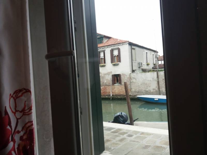 View of Murano canal from the doorway of Giardino holiday flat, Venice Lagoon.