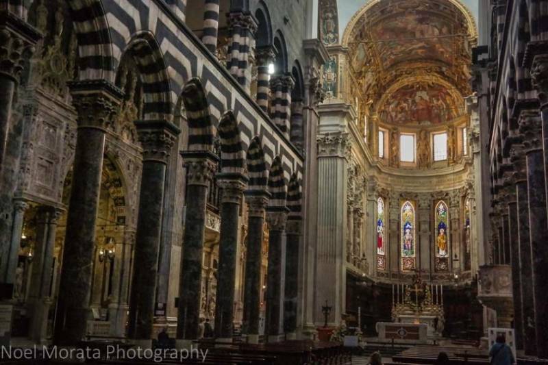 Columns and stained glass windows inside Cattedrale di San Lorenzo in Genoa, Italy.