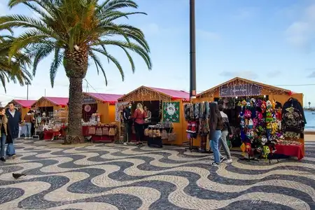 December Christmas market on a sunny seafront in Portugal.