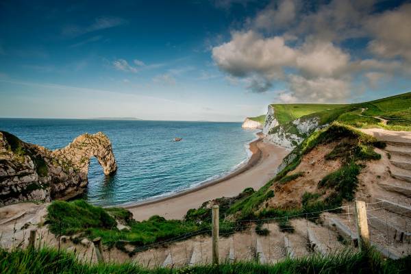 Steps leading to sandy beach and the sea on a Cornwall summer day.