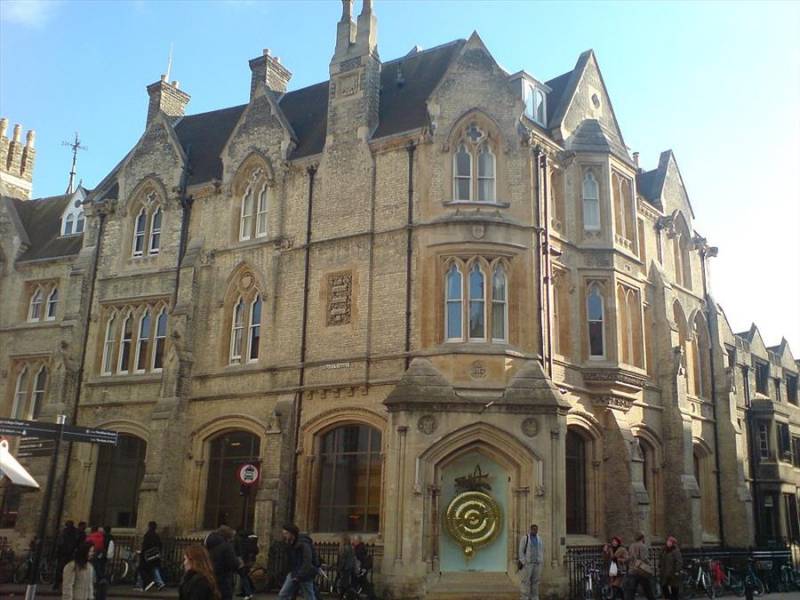 Gold Corpus Clock on Corpus Cristi building in Cambridge, UK.