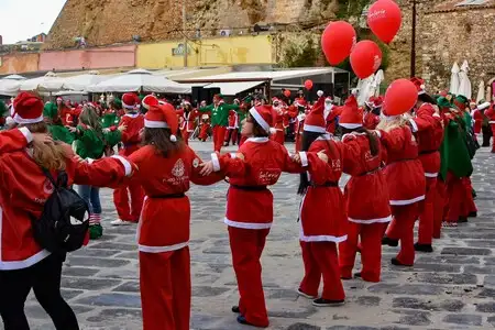 Villagers dressed as Santas doing a traditional Greek dance.