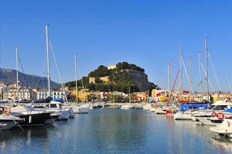 Dénia harbour with castle in distance, Costa Blanca in Spain.