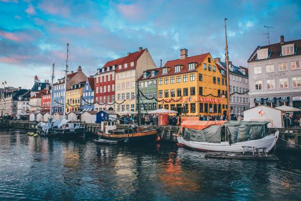 Nyhavn canal with colourful façades and boats in Copenhagen, Denmark.