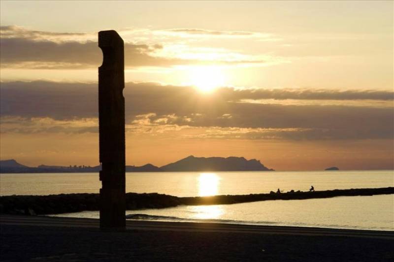 'Monument to the fishermen' stone monolith in the sea at sunrise, El Campello.