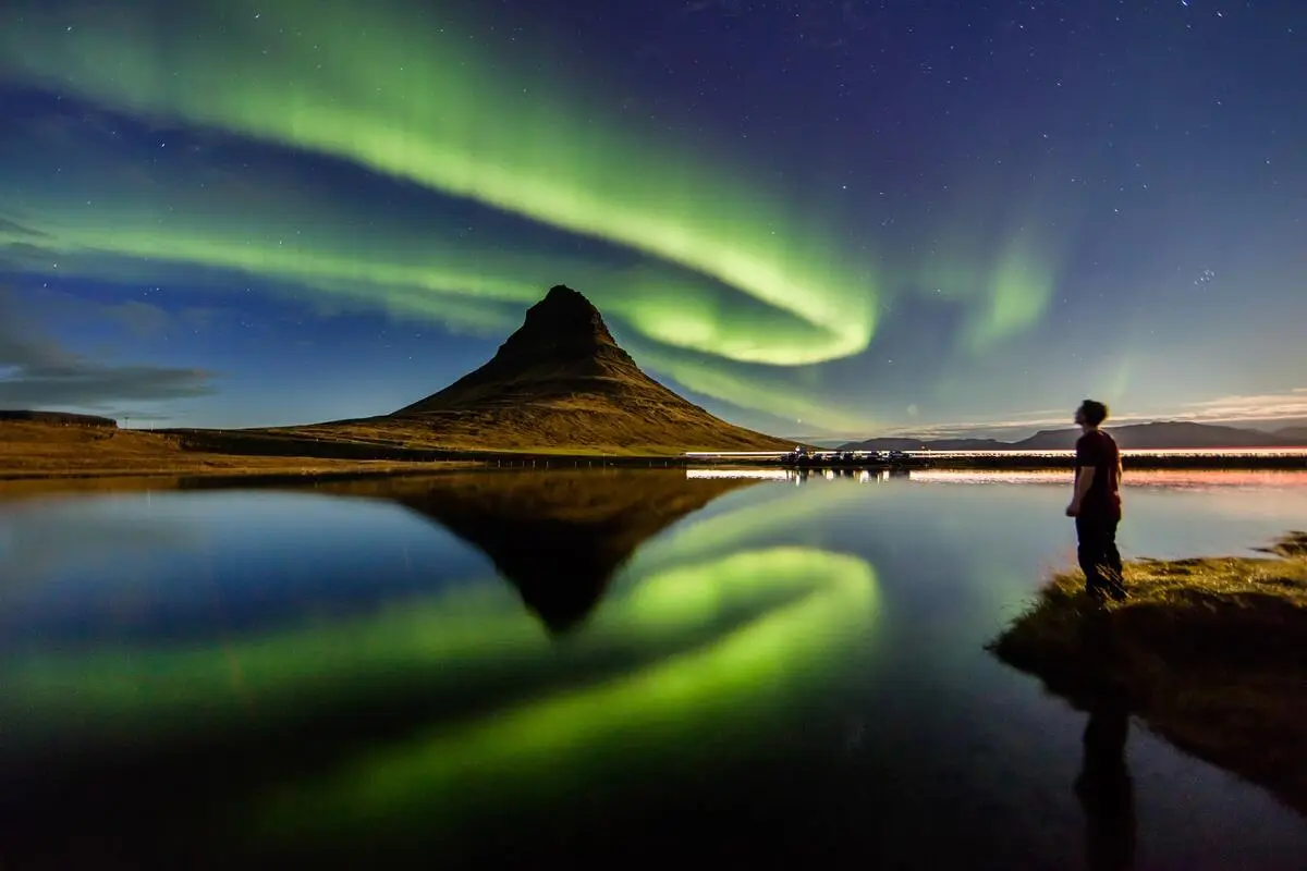Aurora borealis over Kirkjufell Mountain in Iceland on a 7 day trip.