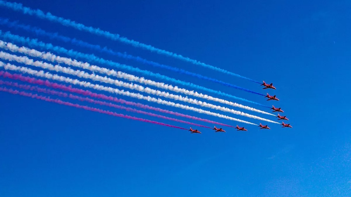 Red Arrows exhibition planes flying over Jersey, Channel Islands.