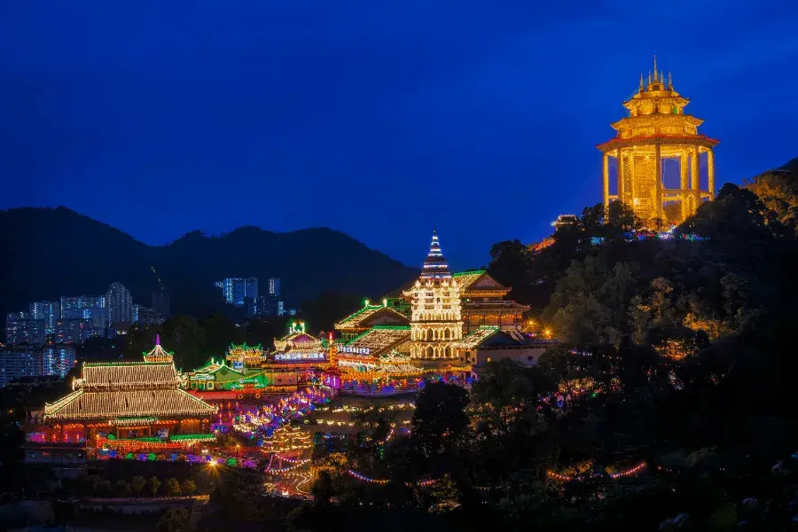 Outside of Buddhist temple complex lit up at night.