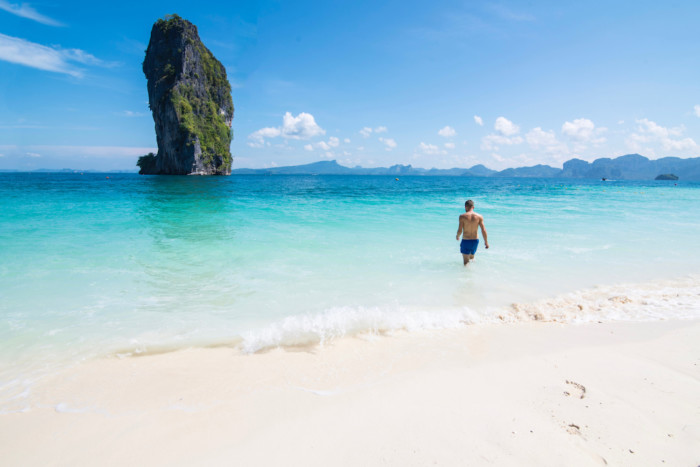 White sands, blue ocean and a seastack at the best Thai island, Koh Poda.