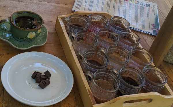 Cup of Kopi Luwak coffee and glass of Bali tea on a tray.