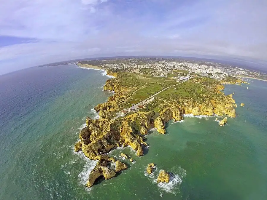 Sunny aerial view of the rocky headland and Algarve coast in southern Portugal
