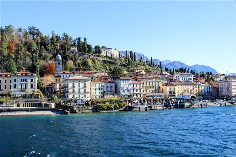 Lake Como with colourful traditional buildings on the shoreline, Italy.