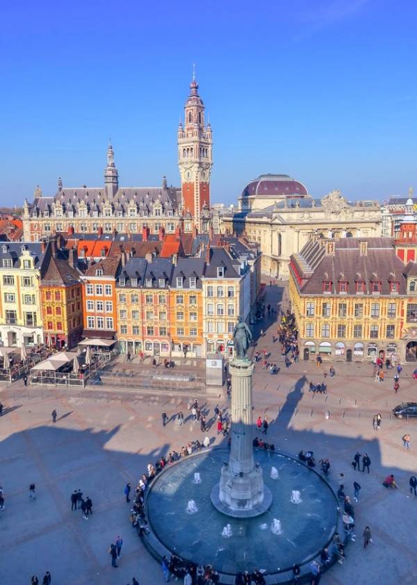 Fountain and monumental buildings in the main square of Lille in France.