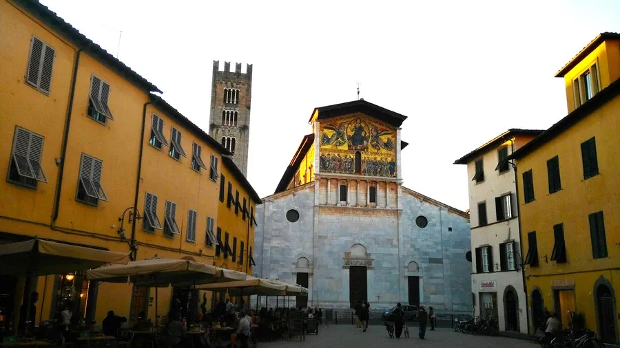 Basilica of San Frediano with huge golden mosaic above a white marble façade.