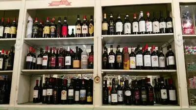 Bottles of wine on display shelves in Antica Drogheria Lucca.
