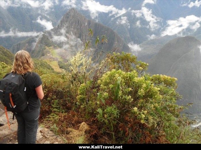 Hiker contemplating Machu Picchu mountain in Peru.
