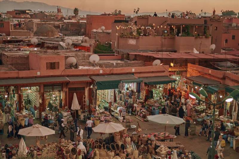 Marrakesh Medina and market glowing pinkly at sunset.