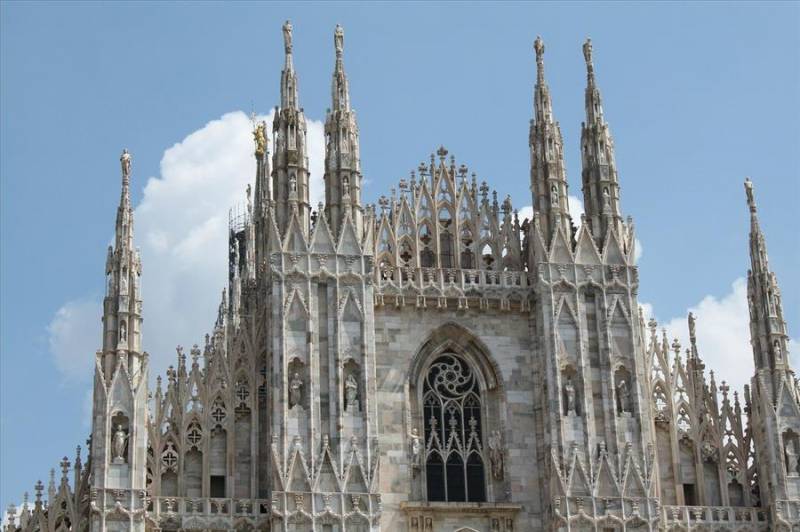 White façade and Gothic towers of Milan Cathedral in North Italy.