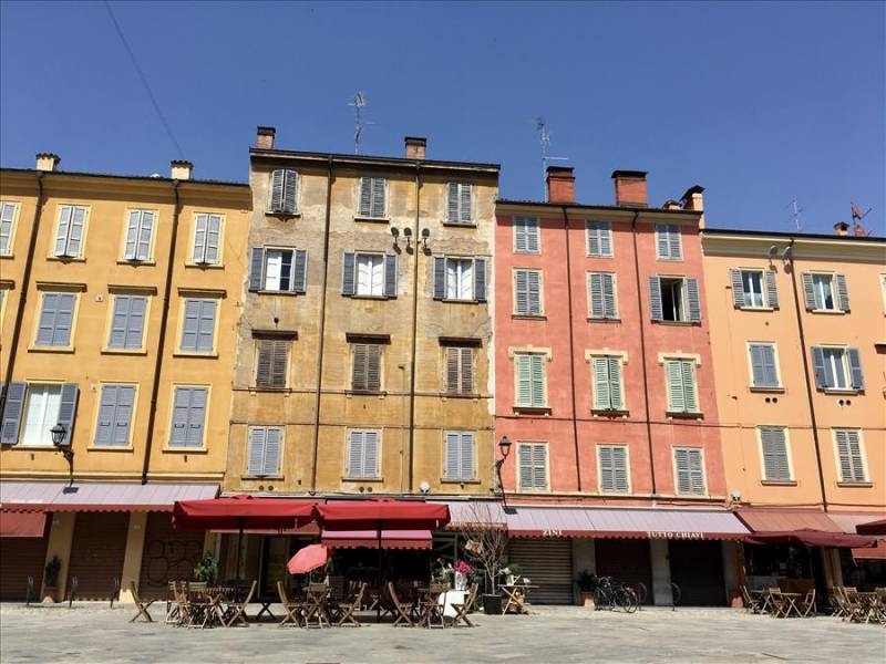 Colourful façades of traditional buildings in Modena, Emilia Romagna region.