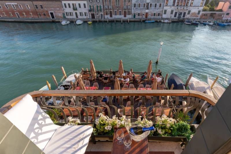 View over the canal terrace at Murano Suites in the Venetian Lagoon, Italy.