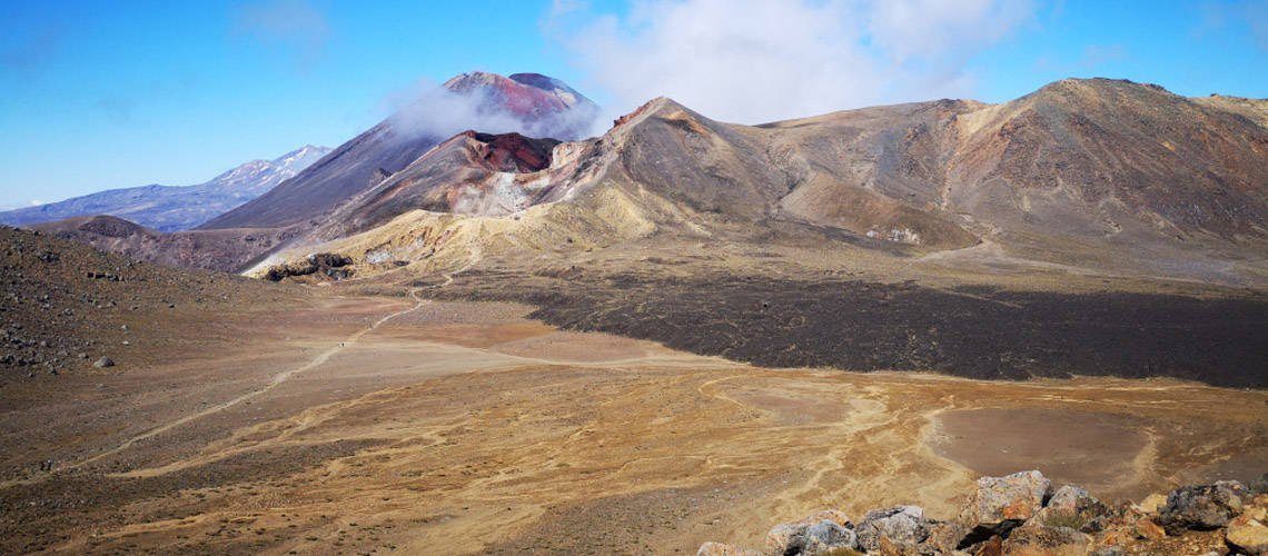 A NZ road trip winds through the barren hills of Tongariro National Park.