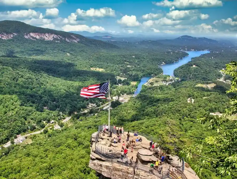 People on Chimney Rock observation platform overlooking the river gorge.