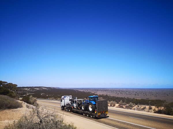 Lorry on straight road crossing the dry plain.