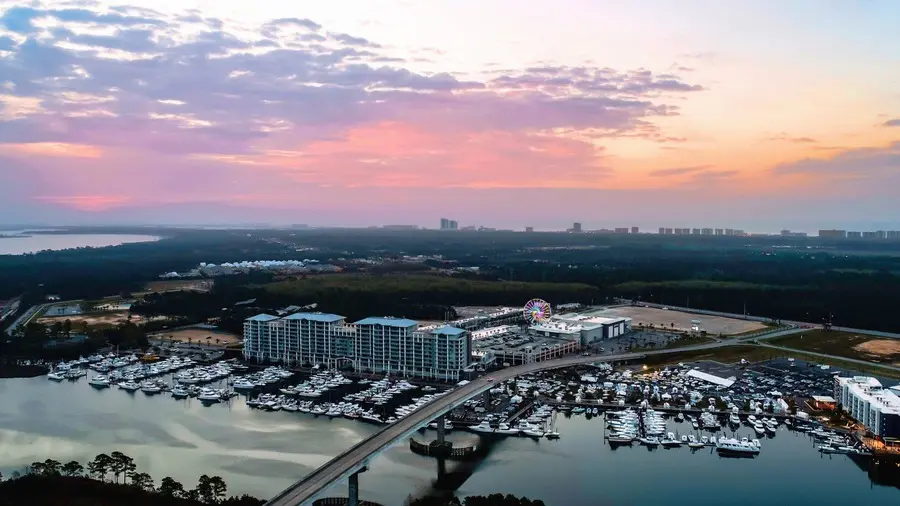 View over Orange Beach waterway and The Wharf leisure complex at sunset. 
