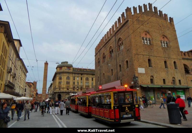 Tourist train beside Palazzo Re Enzo, historical Bologna.