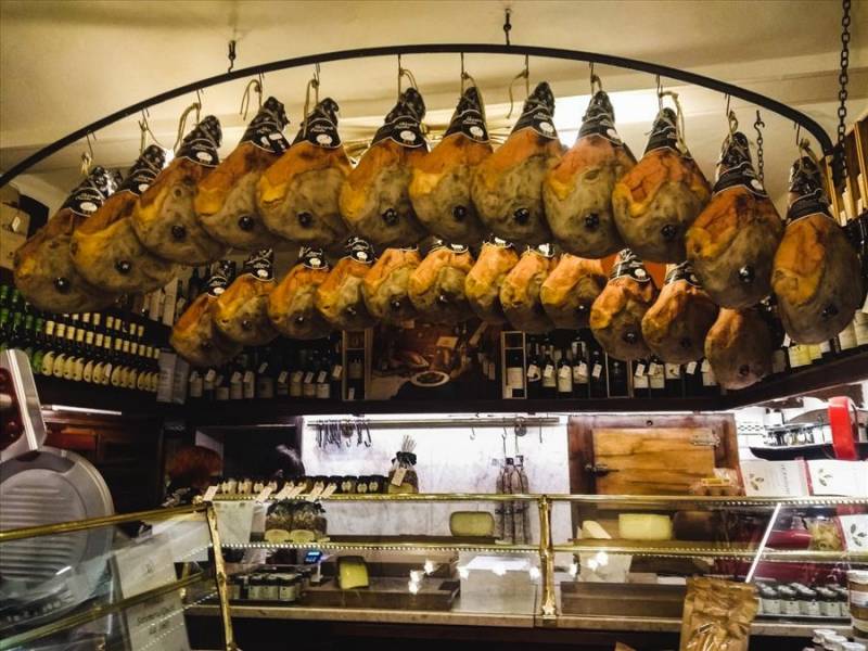 Legs of parma ham 'prosciutto' in delicatessen, Emilia Romagna.