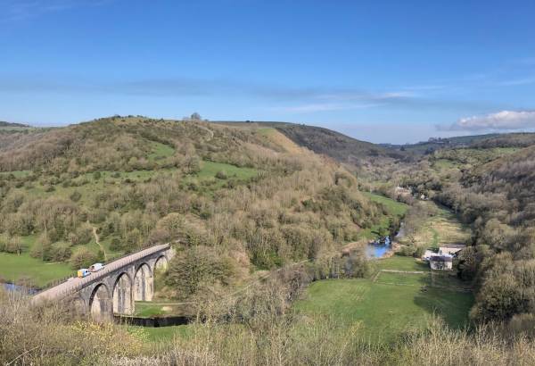Old river bridge and countryside from Monsal Trail in the Peak District.