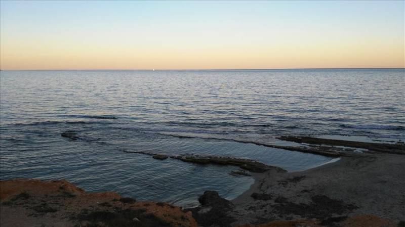 Roman quarry in the sea at sunset in Pilar De La Horadada in Spain.