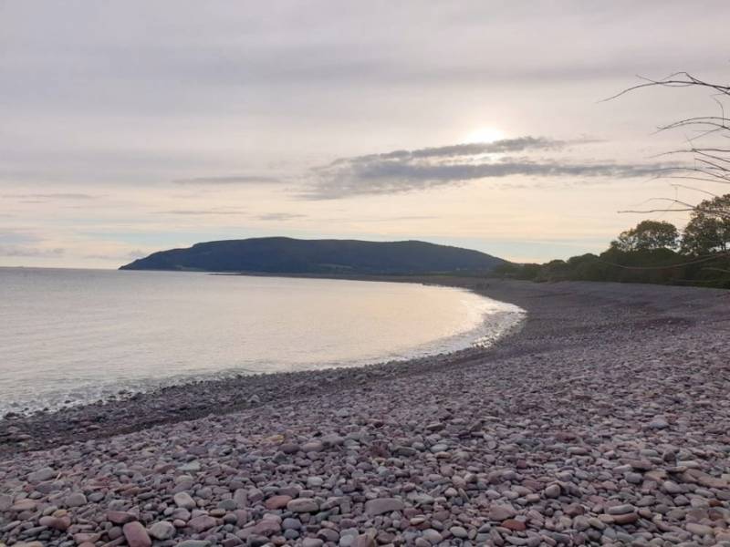 Pebble beach of Porlock Weir at sunset.