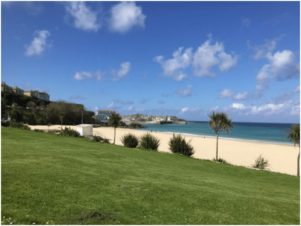 Grass-backed sands leading to sea at Porthminster in summer, Cornwall.