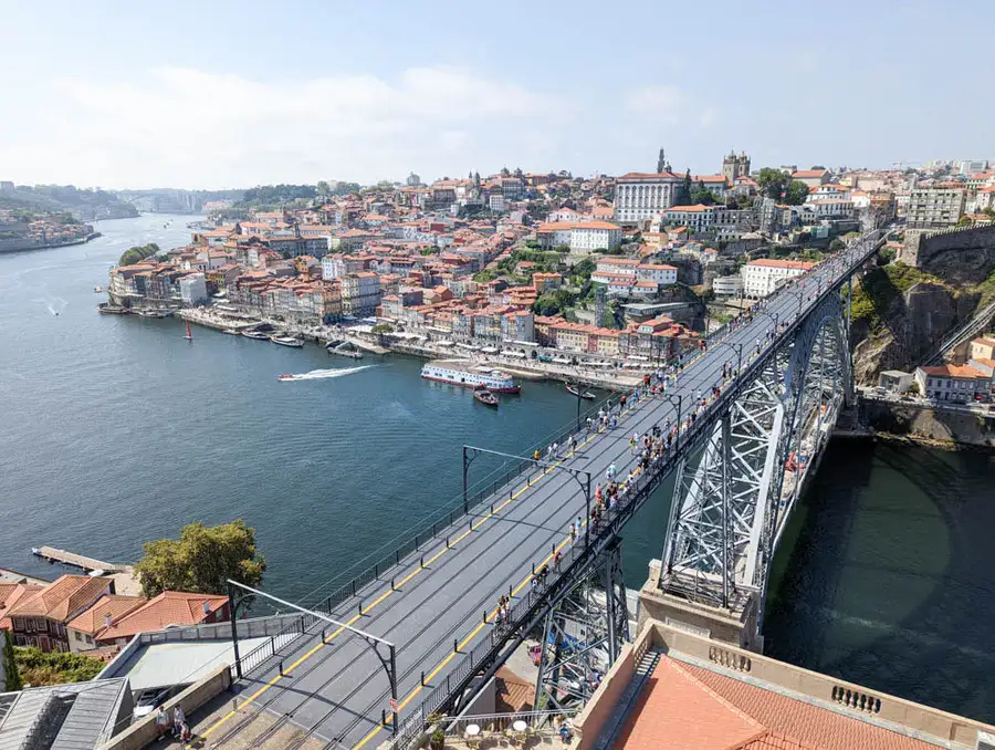 The huge metal bridge spanning River Douro with monumental Porto in the backdrop.